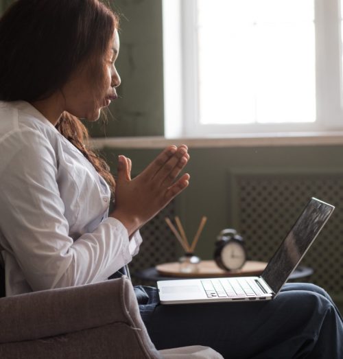 Female on a virtual call on her laptop