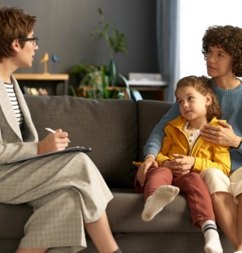 Social worker talking to a parent and child